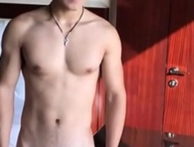 Young Asian boy in jockstrap doing some sniffing and showing off his muscles