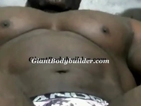A towering American bodybuilder satisfies and overpowers his slender admirer!