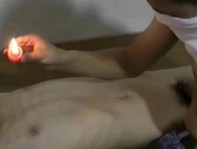 Gay BDSM slave boy in hot wax scene