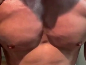 Young Asian man with well built muscles showing off his biceps and getting nipple teasing.