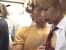 A young Japanese man gets a hand job on a train.