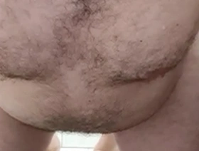 A chubby bear of a man after taking a shower.