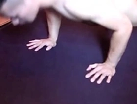 A muscular Asian man posing and flexing his muscles.
