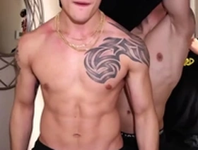 Muscular men with tattoos have sex on the set of a fitness video.
