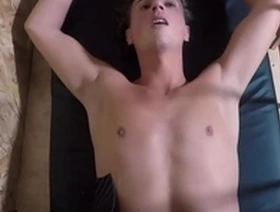 Two hot studs fuck a third on a wall with a fist